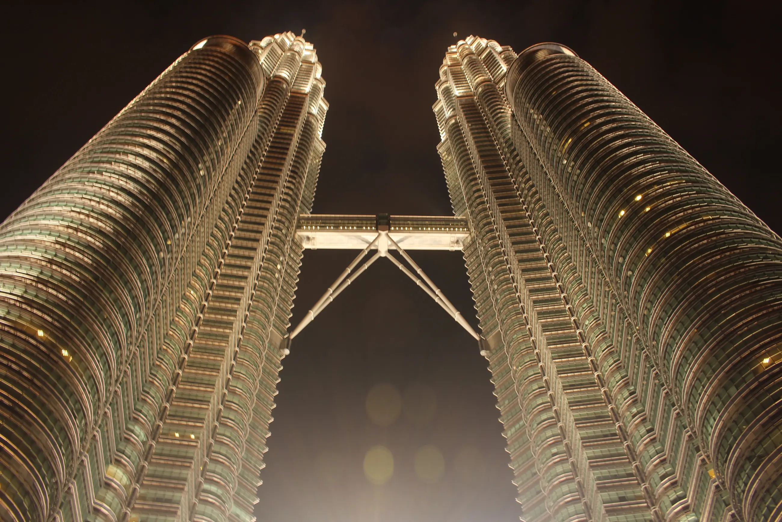 Sharp night view looking up at the Petronas Twin Towers in Kuala Lumpur